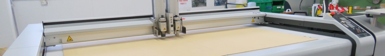 Close-up view of generative line art on paper using a mechanical plotter, showcasing industrial precision.